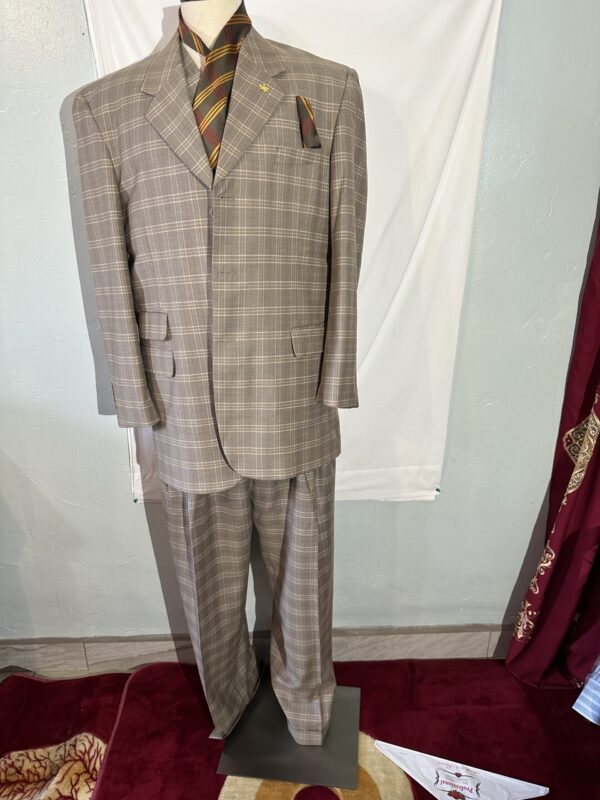 A mannequin dressed up in a sports suit and tie.