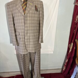 A sports suit on a mannequin in front of a curtain.