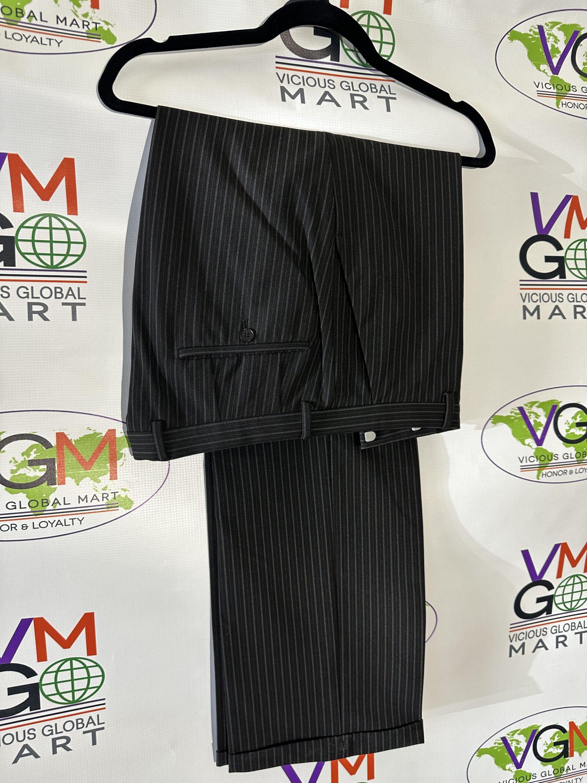 Black striped dress pants on a hanger.