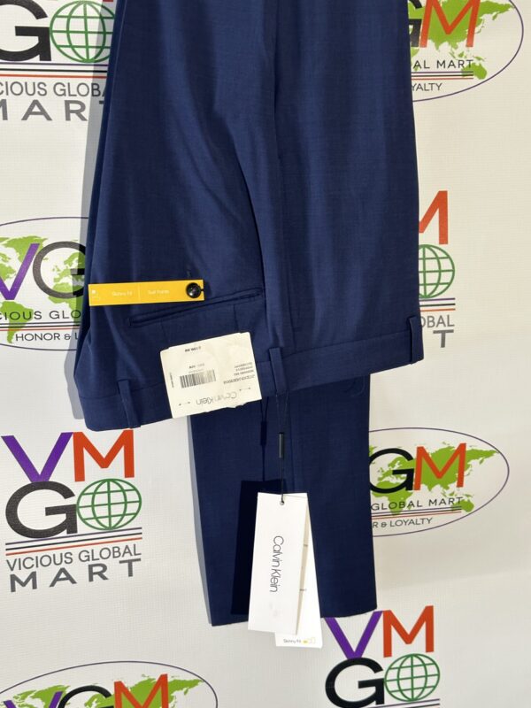 Blue Skinny Dress Pants with a yellow tag on it.