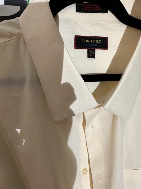 A white Portofilo shirt hanging on a hanger.