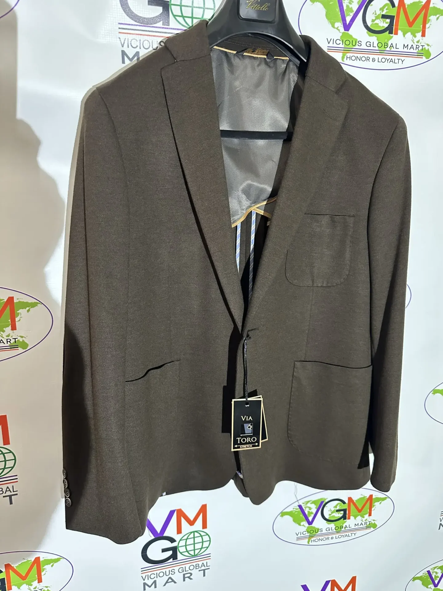 A gray blazer jacket hanging on a hanger.